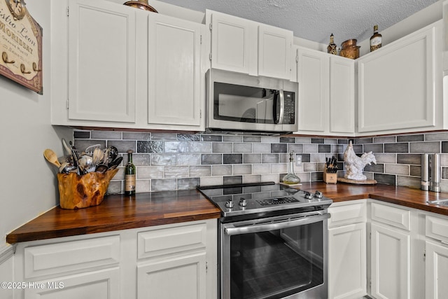 600 N 35th St Unit 201, Morehead City, NC 28557 - kitchen with stainless steel appliances, wooden counters, white cabinets, and a textured ceiling