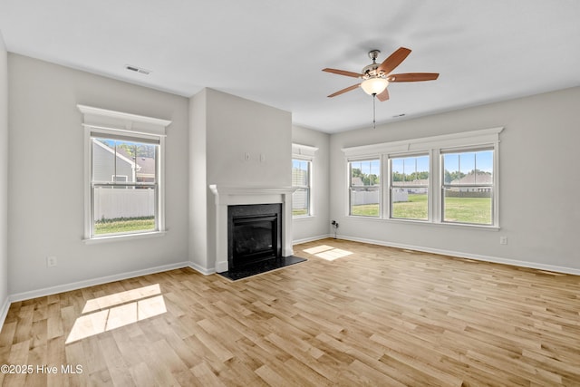 132 Mill Run, South Mills, NC 27976 - unfurnished living room with light wood-type flooring, a high end fireplace, and a ceiling fan