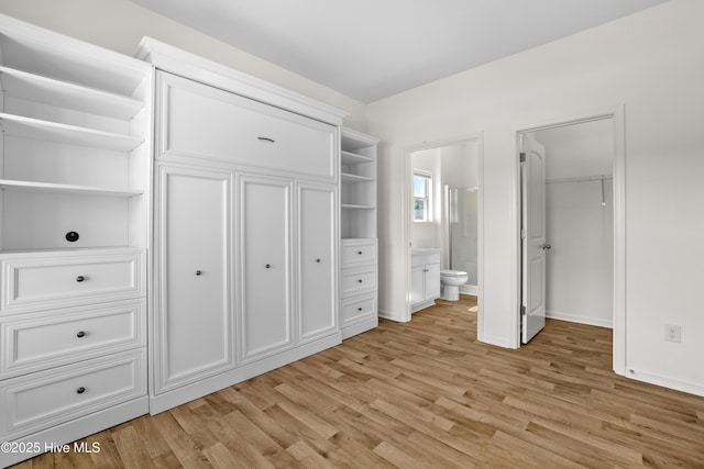 132 Mill Run, South Mills, NC 27976 - unfurnished bedroom featuring light wood-style floors, ensuite bathroom, a spacious closet, and a closet