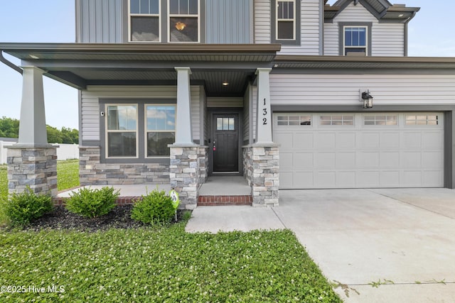 132 Mill Run, South Mills, NC 27976 - view of front facade with a porch, concrete driveway, stone siding, a garage, and board and batten siding