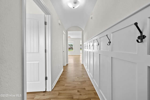 132 Mill Run, South Mills, NC 27976 - hall with light wood-style flooring, arched walkways, and a textured wall