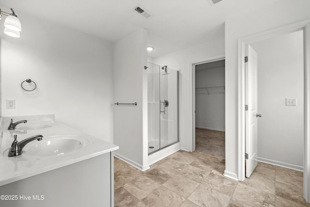 132 Mill Run, South Mills, NC 27976 - full bath featuring a stall shower, a walk in closet, and double vanity