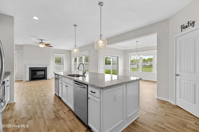 132 Mill Run, South Mills, NC 27976 - kitchen with dishwasher, a fireplace, open floor plan, a ceiling fan, and light wood-style flooring