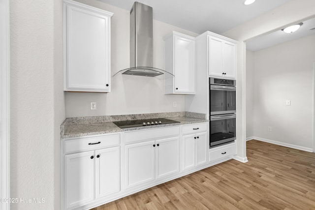132 Mill Run, South Mills, NC 27976 - kitchen featuring range hood, stainless steel double oven, black electric cooktop, light wood finished floors, and white cabinets