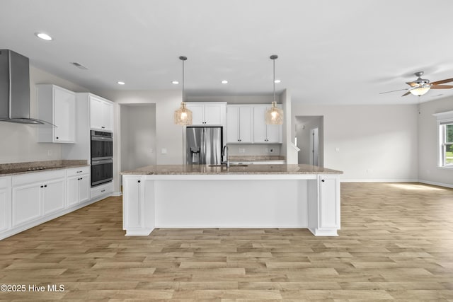 132 Mill Run, South Mills, NC 27976 - kitchen featuring wall chimney exhaust hood, stainless steel fridge, double wall oven, light wood-style floors, and recessed lighting