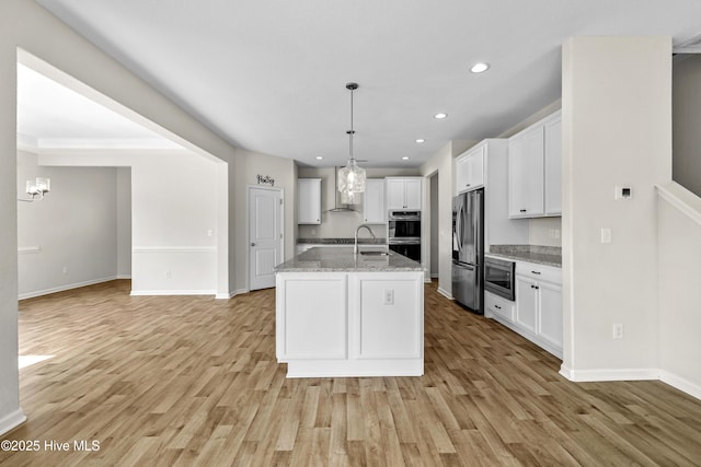 132 Mill Run, South Mills, NC 27976 - kitchen featuring appliances with stainless steel finishes, white cabinets, wall chimney range hood, light wood-style flooring, and recessed lighting