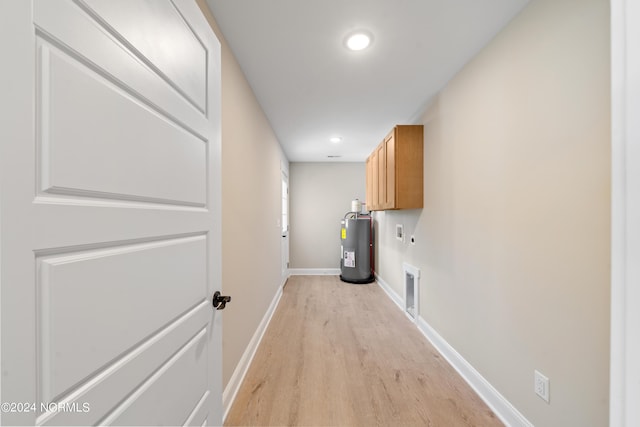 72 S Greensboro Rd, Southport, NC 28461 - laundry room featuring cabinet space, water heater, light wood finished floors, recessed lighting, and washer hookup