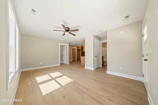 72 S Greensboro Rd, Southport, NC 28461 - unfurnished living room featuring light wood finished floors, a ceiling fan, and plenty of natural light