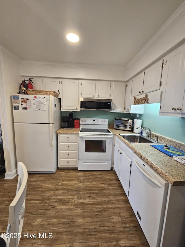 2008 E Ft Macon Rd Unit E14, Atlantic Beach, NC 28512 - kitchen with white appliances, crown molding, dark wood-style flooring, white cabinets, and light countertops
