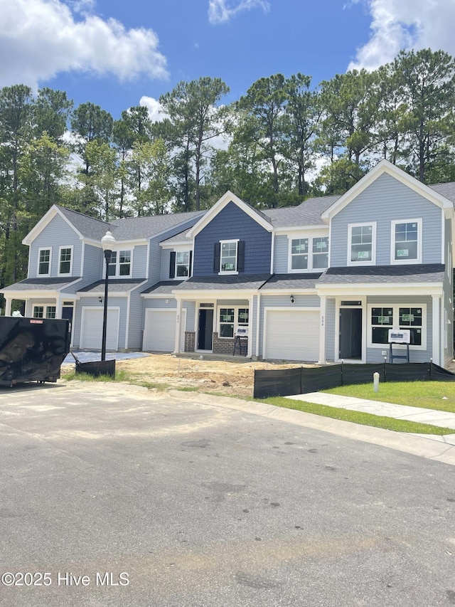 804 Palm Frond Way, Calabash, NC 28467 - view of property featuring covered porch, an attached garage, and driveway