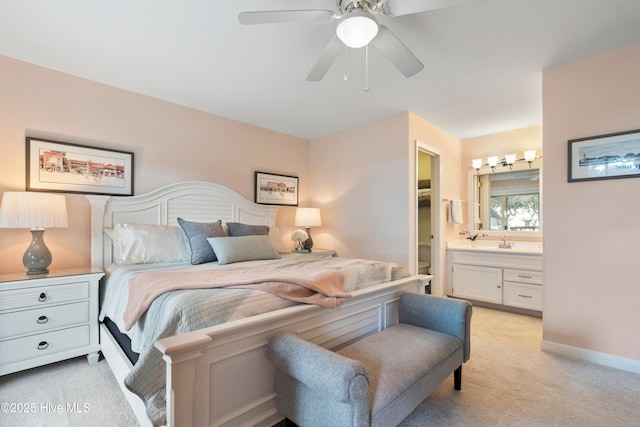 11 Foxfire Trce, Oak Island, NC 28465 - bedroom with light colored carpet, ensuite bathroom, and a ceiling fan