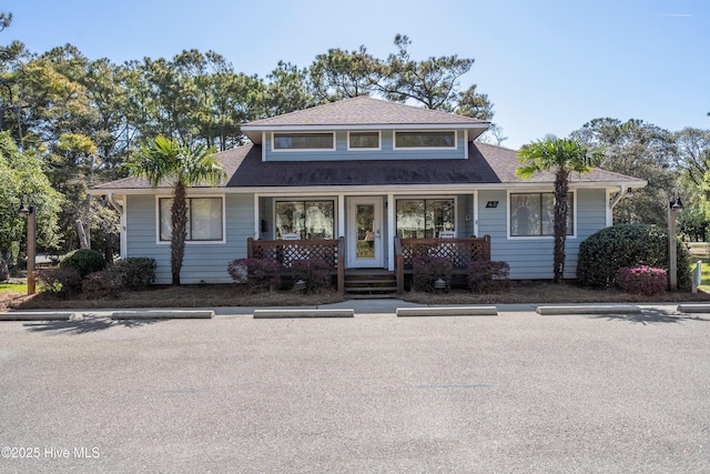 11 Foxfire Trce, Oak Island, NC 28465 - bungalow featuring a porch, uncovered parking, and a shingled roof