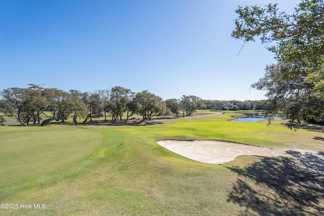 11 Foxfire Trce, Oak Island, NC 28465 - view of home's community featuring golf course view, a water view, and a lawn