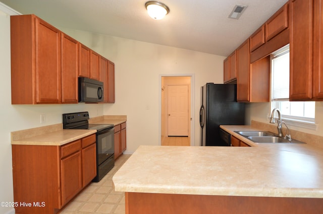 140 Van Riggs Rd, Hubert, NC 28539 - kitchen featuring black appliances, vaulted ceiling, light countertops, a peninsula, and light floors