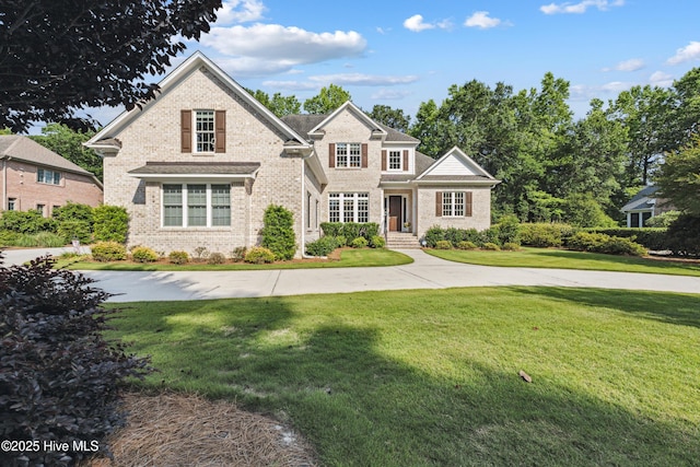 8812 Fazio Dr, Wilmington, NC 28411 - traditional-style house with brick siding and a front lawn