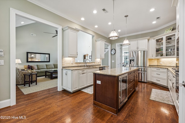 8812 Fazio Dr, Wilmington, NC 28411 - kitchen featuring stainless steel fridge with ice dispenser, glass insert cabinets, tasteful backsplash, white cabinets, and crown molding