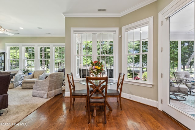 8812 Fazio Dr, Wilmington, NC 28411 - dining room with a ceiling fan, dark wood-type flooring, plenty of natural light, and crown molding