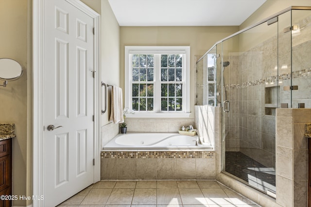 8812 Fazio Dr, Wilmington, NC 28411 - full bathroom featuring a jetted tub, vanity, a stall shower, and tile patterned floors