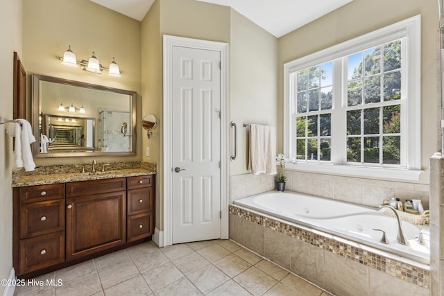 8812 Fazio Dr, Wilmington, NC 28411 - full bath with a whirlpool tub, vanity, healthy amount of natural light, and tile patterned floors