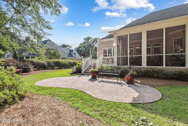 8812 Fazio Dr, Wilmington, NC 28411 - view of green lawn with a patio and a sunroom