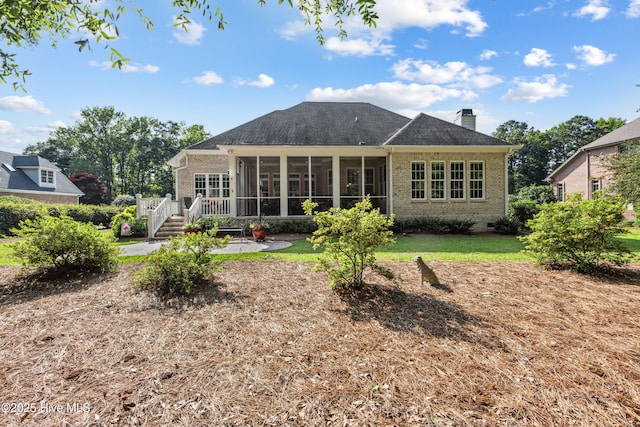 8812 Fazio Dr, Wilmington, NC 28411 - back of house featuring a sunroom, brick siding, a chimney, a wooden deck, and a yard