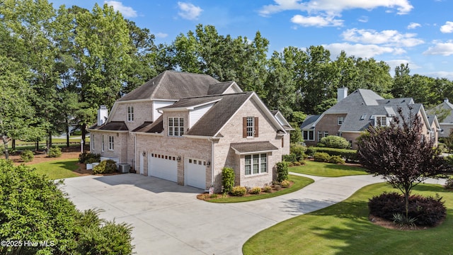 8812 Fazio Dr, Wilmington, NC 28411 - view of front facade featuring driveway, a front yard, an attached garage, and brick siding