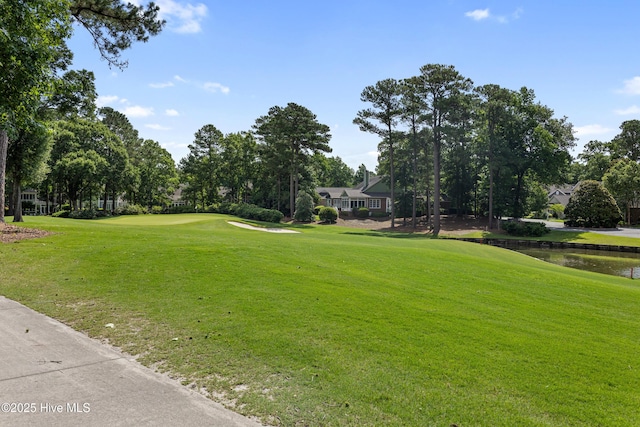 8812 Fazio Dr, Wilmington, NC 28411 - view of property's community featuring view of golf course, a yard, a water view, and view of scattered trees