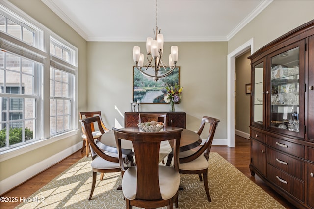 8812 Fazio Dr, Wilmington, NC 28411 - dining area featuring ornamental molding, a chandelier, and dark wood-type flooring