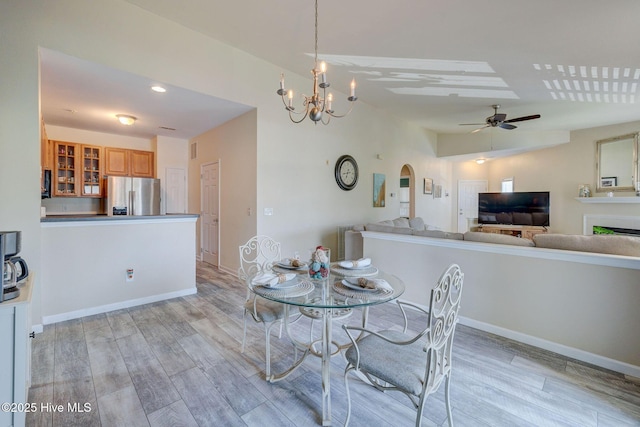 213 Fullford Ln Unit 201, Wilmington, NC 28412 - dining space featuring light wood-type flooring, ceiling fan, a chandelier, and arched walkways