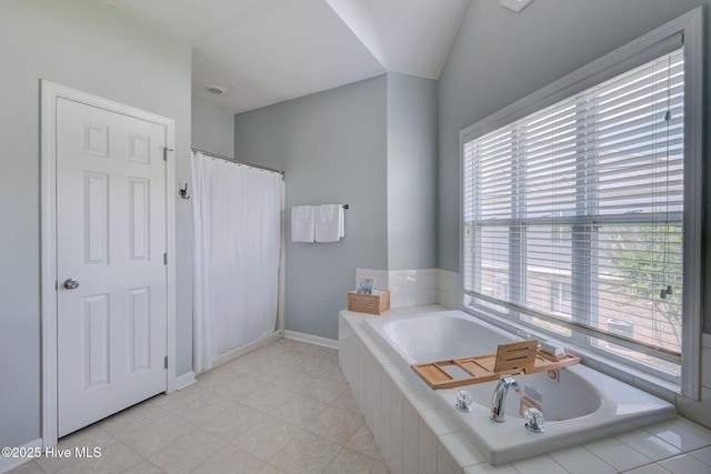213 Fullford Ln Unit 201, Wilmington, NC 28412 - bathroom with healthy amount of natural light, a garden tub, a shower with curtain, and tile patterned floors