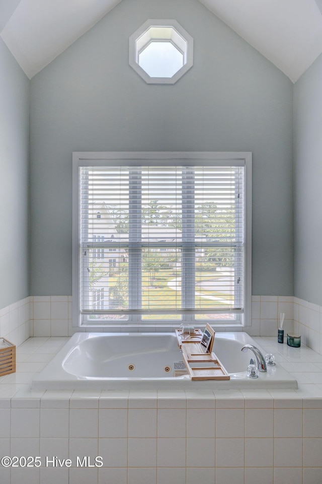 213 Fullford Ln Unit 201, Wilmington, NC 28412 - bathroom featuring lofted ceiling, healthy amount of natural light, and a jetted tub