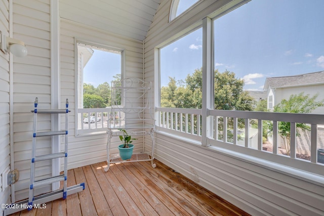 213 Fullford Ln Unit 201, Wilmington, NC 28412 - unfurnished sunroom featuring lofted ceiling, hardwood / wood-style floors, wood walls, and plenty of natural light