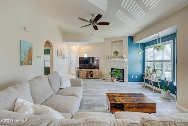 213 Fullford Ln Unit 201, Wilmington, NC 28412 - living room with arched walkways, ceiling fan, wood finished floors, and a fireplace with flush hearth