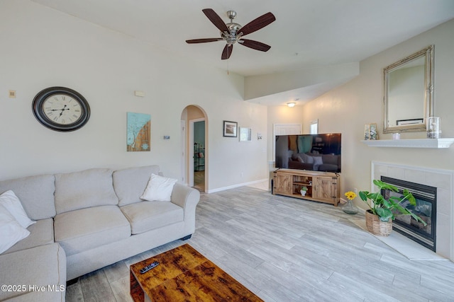 213 Fullford Ln Unit 201, Wilmington, NC 28412 - living room featuring arched walkways, a ceiling fan, wood finished floors, a tiled fireplace, and lofted ceiling