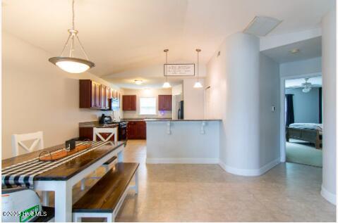 226 Bandon Dr, New Bern, NC 28562 - dining area with a ceiling fan, lofted ceiling, and light floors