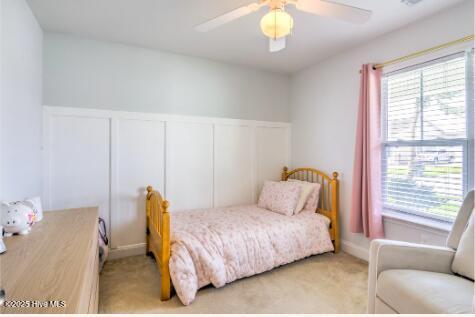 226 Bandon Dr, New Bern, NC 28562 - bedroom featuring a decorative wall, light colored carpet, wainscoting, and ceiling fan