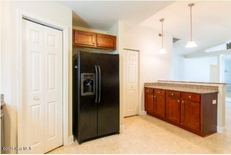 226 Bandon Dr, New Bern, NC 28562 - kitchen featuring black fridge, a peninsula, brown cabinets, decorative light fixtures, and lofted ceiling