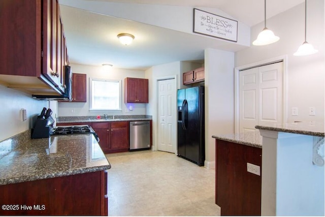 226 Bandon Dr, New Bern, NC 28562 - kitchen with stainless steel appliances, dark stone countertops, light floors, decorative light fixtures, and reddish brown cabinets