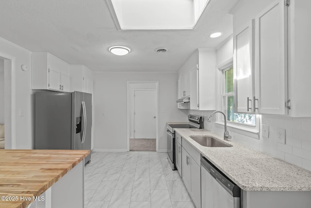 1292 Lake Cole Rd, Midway Park, NC 28544 - kitchen featuring stainless steel appliances, light marble finish floors, white cabinets, decorative backsplash, and under cabinet range hood
