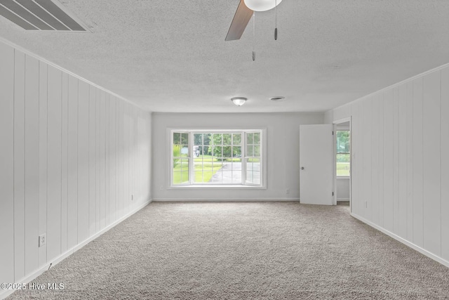 1292 Lake Cole Rd, Midway Park, NC 28544 - unfurnished room featuring carpet floors, a ceiling fan, a textured ceiling, and wooden walls