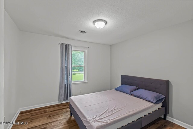 1292 Lake Cole Rd, Midway Park, NC 28544 - bedroom with dark wood-type flooring and a textured ceiling