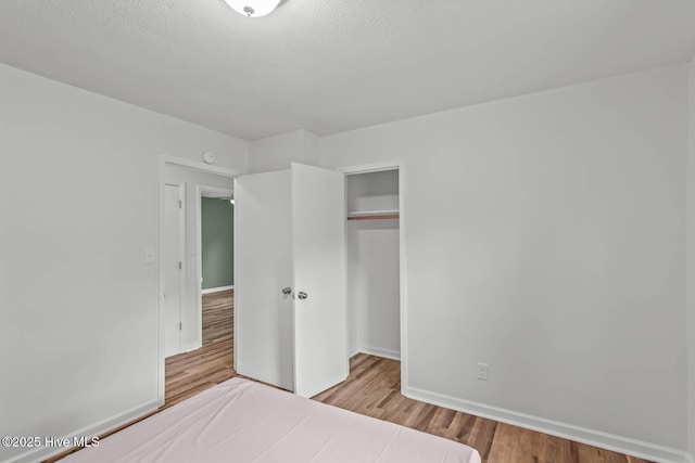1292 Lake Cole Rd, Midway Park, NC 28544 - bedroom with wood finished floors, a closet, and a textured ceiling