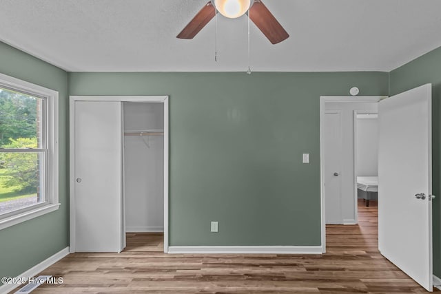 1292 Lake Cole Rd, Midway Park, NC 28544 - unfurnished bedroom featuring wood finished floors, a closet, and a ceiling fan