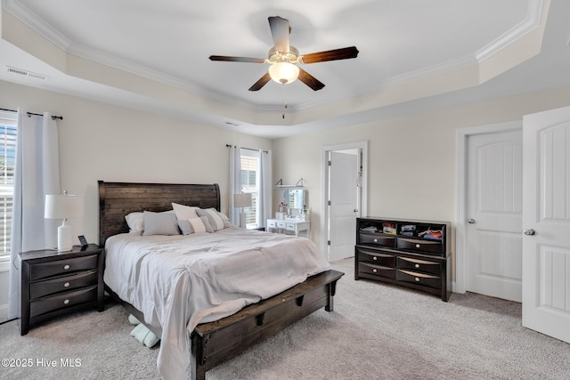 324 Windmill Light Way, Sneads Ferry, NC 28460 - bedroom with ornamental molding, light colored carpet, a tray ceiling, and a ceiling fan