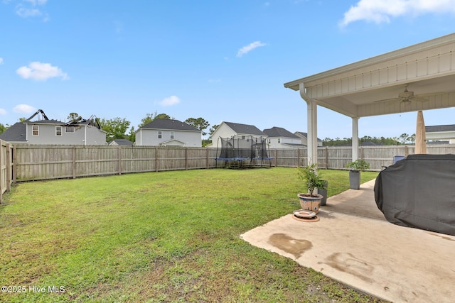 324 Windmill Light Way, Sneads Ferry, NC 28460 - fenced backyard featuring a trampoline, a ceiling fan, a patio, and a residential view