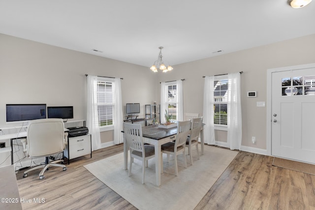 324 Windmill Light Way, Sneads Ferry, NC 28460 - dining area with light wood-type flooring, a chandelier, plenty of natural light, and an office area