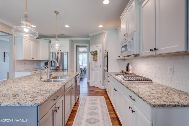 110 E Conolly Ct, Hampstead, NC 28443 - kitchen with stainless steel appliances, crown molding, dark wood-type flooring, tasteful backsplash, and recessed lighting