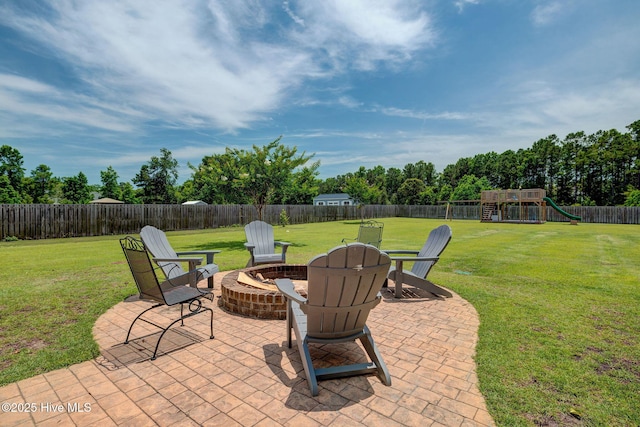 110 E Conolly Ct, Hampstead, NC 28443 - fenced backyard with a fire pit, a patio, and a playground