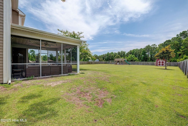 110 E Conolly Ct, Hampstead, NC 28443 - fenced backyard with a storage shed, a playground, a sunroom, and a ceiling fan