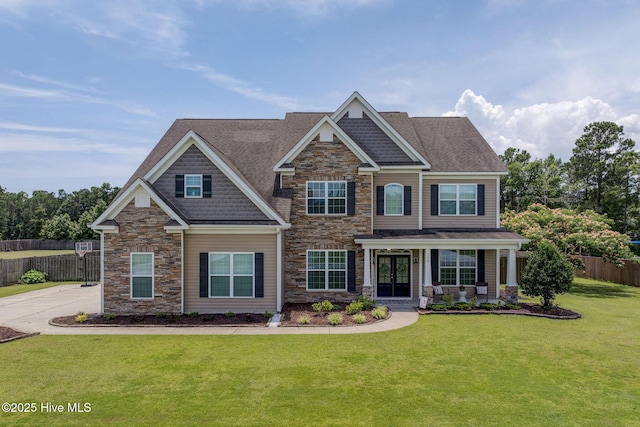 110 E Conolly Ct, Hampstead, NC 28443 - craftsman house featuring stone siding, covered porch, and roof with shingles